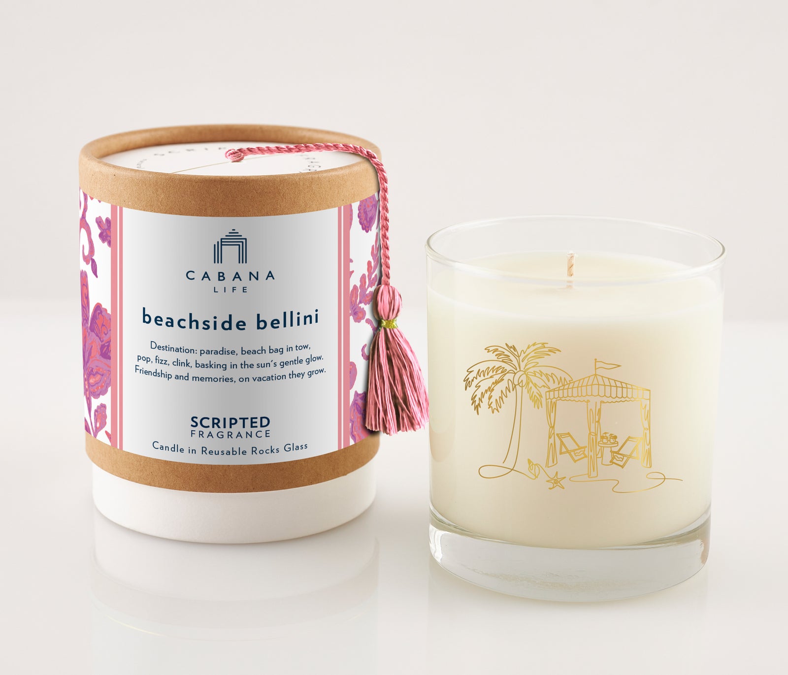 Peachy and plush, the Beachside Bellini candle in a gold-detailed sustainable glass pairs perfectly with Cabana Life’s soft, pastel resortwear.