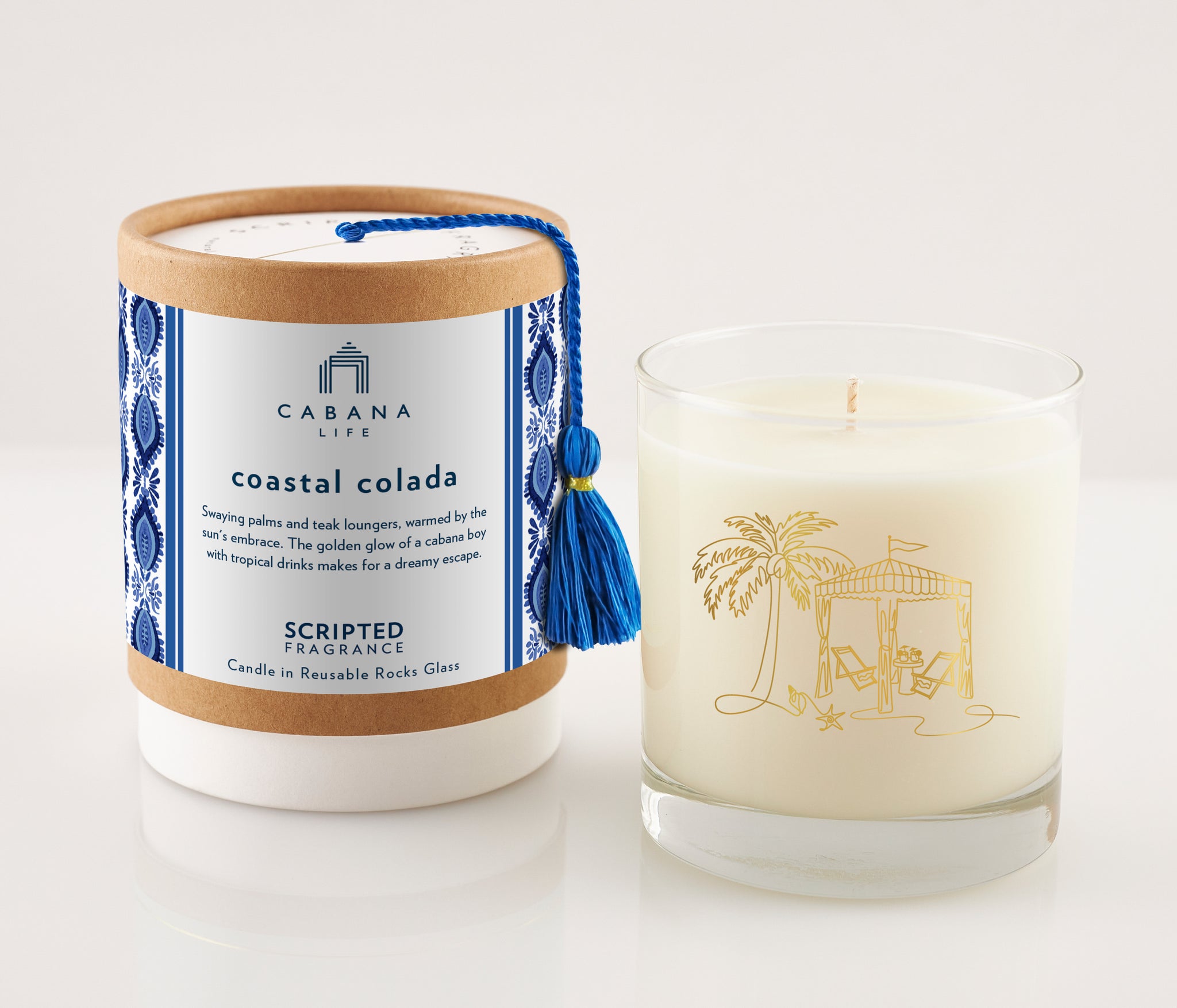 Coastal Colada candle in a 22k gold-accented sustainable rocks glass, filled with 100% soy wax; evokes tropical vibes perfect for pairing with Cabana Life’s palm-print swimwear.