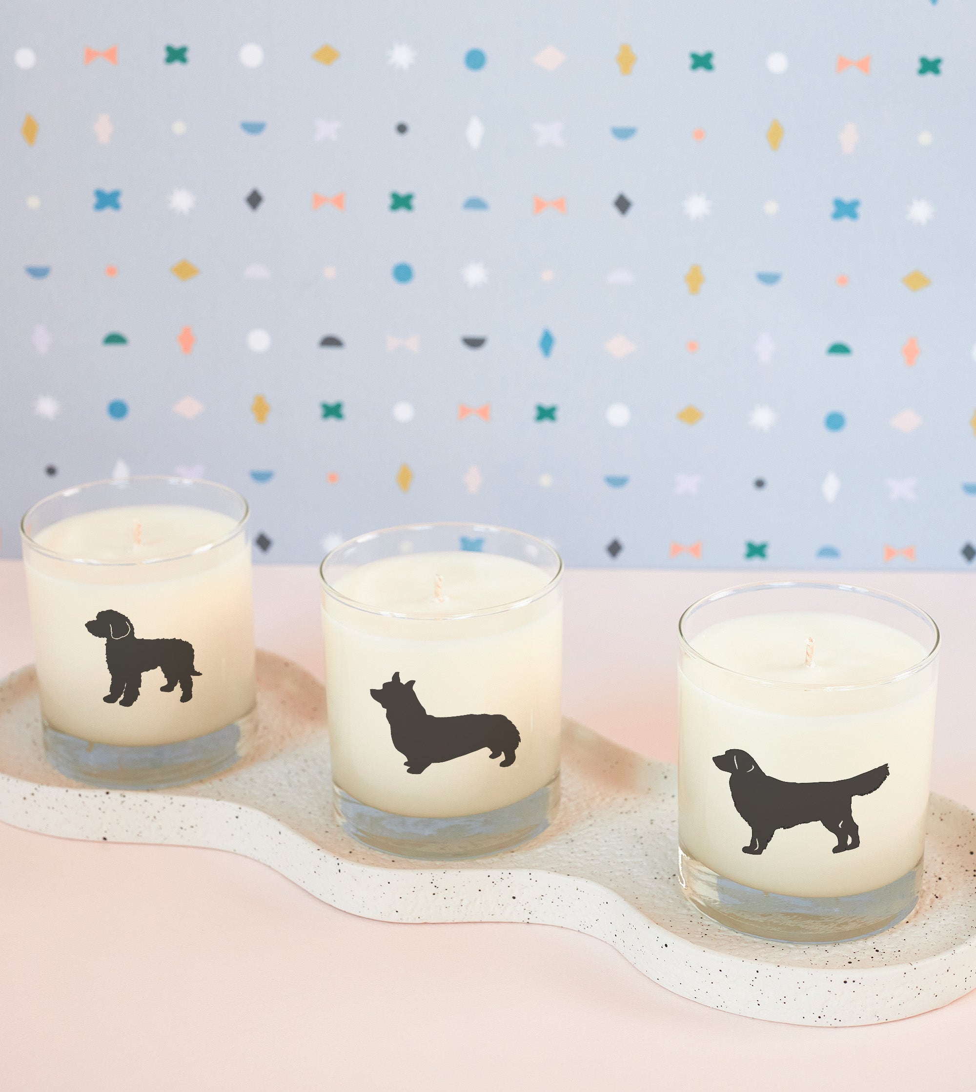 Assorted soy candles for pet lovers, including French bulldog, rescue dog, and goldendoodle designs in drink-safe reusable vessels.