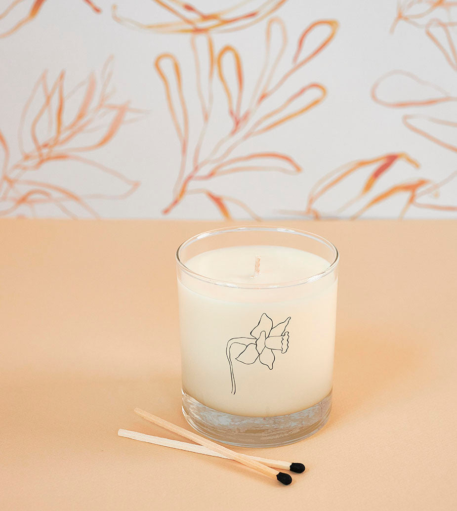 Elegant daffodil candle for March, hand-poured in reusable drinking glass, sustainable and gift-ready