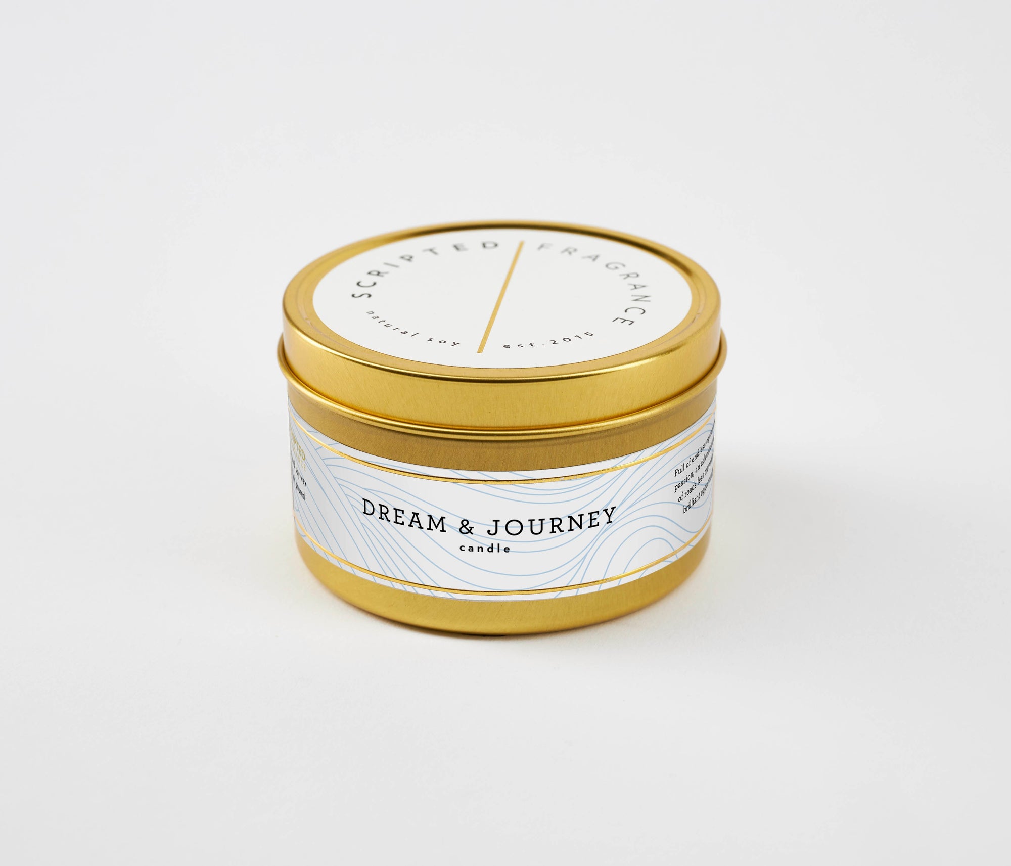 Travel-ready Dream & Journey soy candle in gold tin – bright citrus and green tea fragrance for on-the-go inspiration.