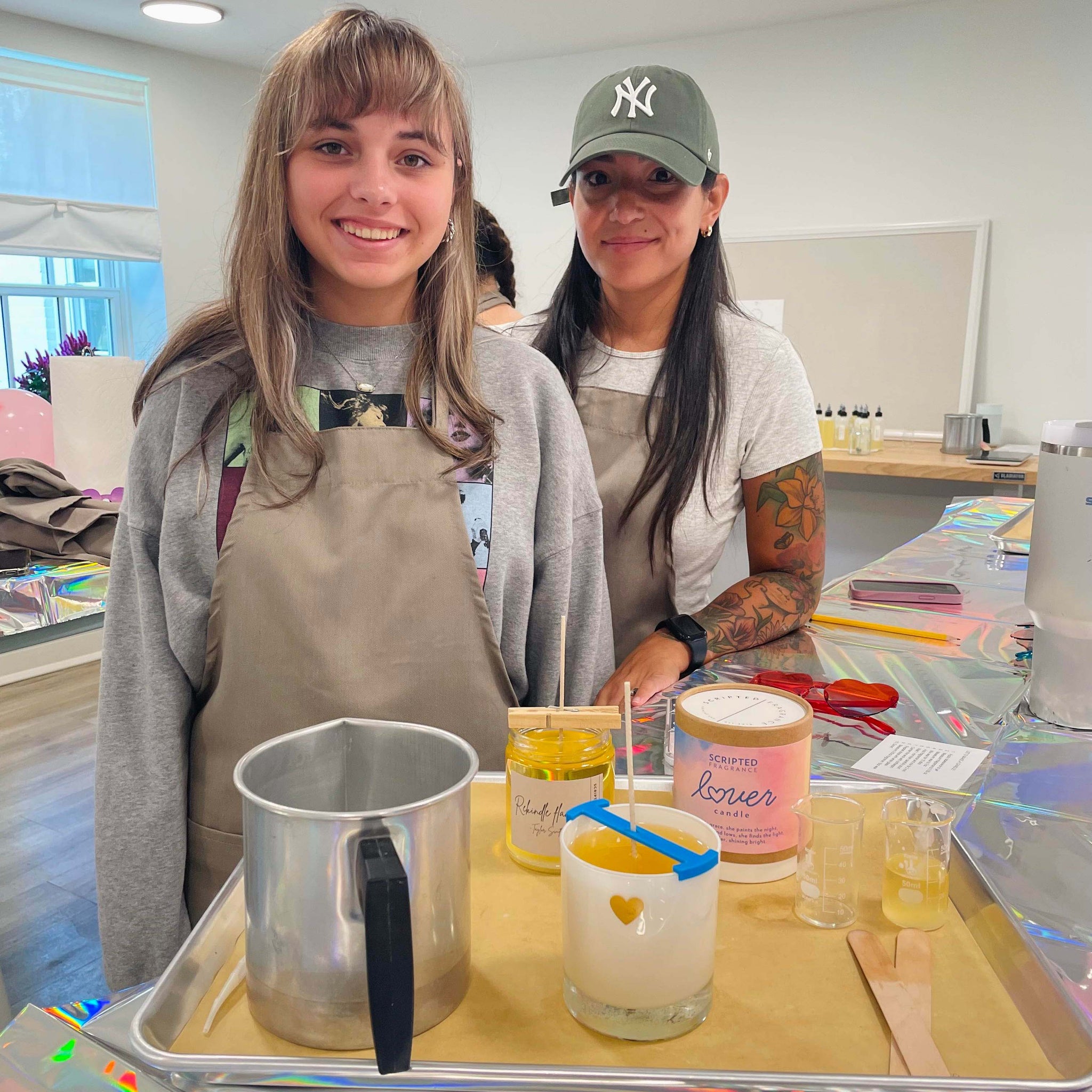 Guests hand-pouring candles at a Taylor Swift-themed candle-making class