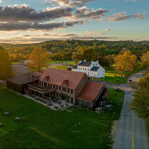 Aerial view of the Scripted Fragrance Manor House in Warwick, NY, beside Drowned Lands Brewery in fall