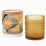 Golden Grace fall candle and reusable drinking glass by Scripted Fragrance, beside its kraft packaging with the Scripted Story poem label